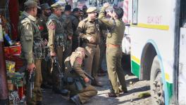 Police personnel inspect the site after a powerful explosion at a bus stand in Jammu on Thursday.