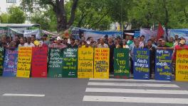 Members of various peasants' federations protest in front UN office in Bangkok.