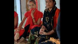 Mandakini with her sister in red suit with black stole on right side.