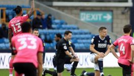 Millwall and Colchester players take a knee