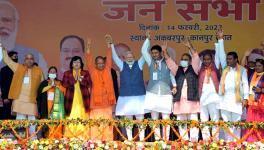 Kanpur Dehat, Feb 14 (ANI): Prime Minister Narendra Modi with Uttar Pradesh Chief Minister Yogi Adityanath and others raises hands at a public meeting, in Kanpur Dehat district of Uttar Pradesh on Monday. (ANI Photo)