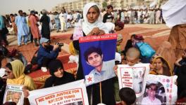 Family members of missing Pakistanis people hold their relatives' pictures at a protest rally of Pashtun Tahafuz Movement (PTM) in Karachi