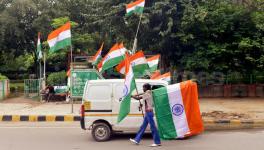 A street vendor sell tricolor flag at traffic red light on the eve of independence day in New Delhi 