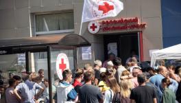 War-displaced people receive humanitarian aid at a Russian Red Cross distribution point in Kursk, August 15, 2024 