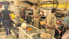 Police officials inspecting a restaurant kitchen in Dehradun on Wednesday.