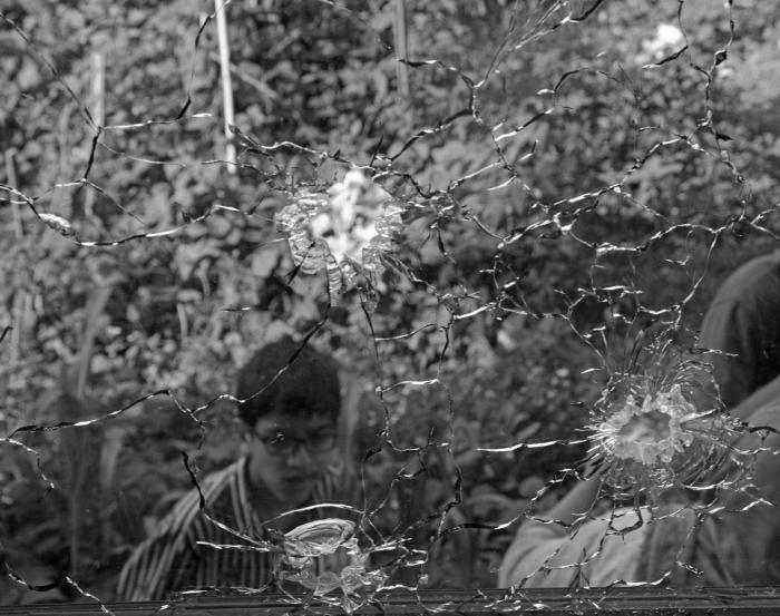 (A boy standing outside a house following an encounter between militants and government forces in Malbagh locality of Srinagar on July 3, 2020. A militant and a CRPF trooper were killed during the encounter in the city outskirts). 