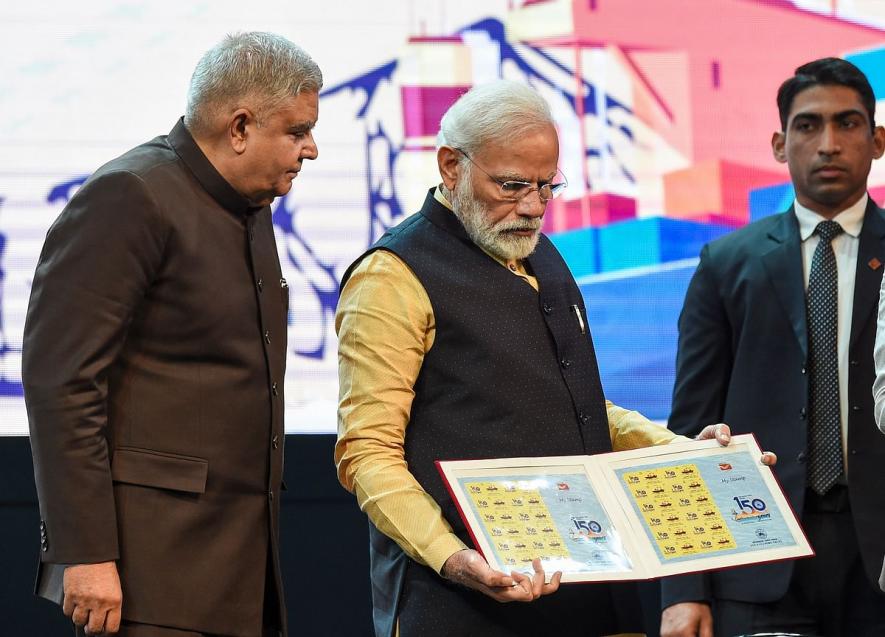 Prime Minister Narendra Modi releases a stamp in the presence of West Bengal Governor Jagdeep Dhankhar during an event to celebrate 150 years of Kolkata Port Trust.