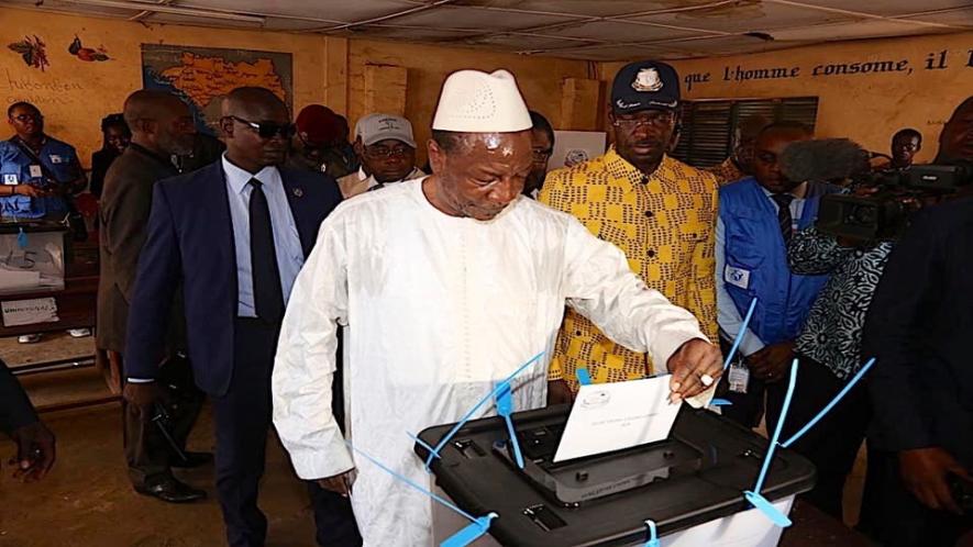 President Alpha Conde, who has been accused of electoral fraud and authoritarian tendencies, casts his vote on Sunday. (Photo: Twitter)