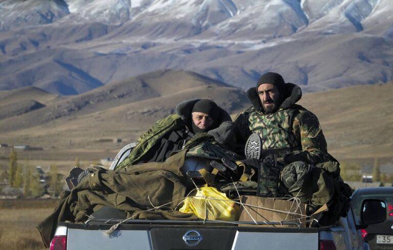 Armenian soldiers ride a car passing the border between Nagorno-Karabakh and Armenia near Vardenis, Sunday, Nov. 8, 2020.