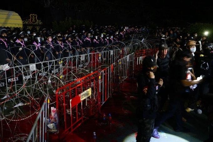 Protesters threw red paint on the barricades put up by the Thai police to represent the violent repression of the “Red Shirts” in past democratic protests. (Photo: Prachatai)