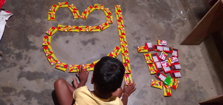 A child writing first letter of Odia script