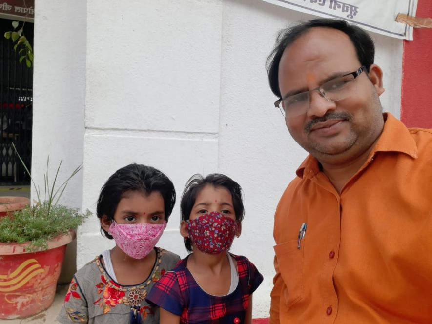 The twin sisters, Mahi and Ruhi with their grandfather, Subhash Raikwar