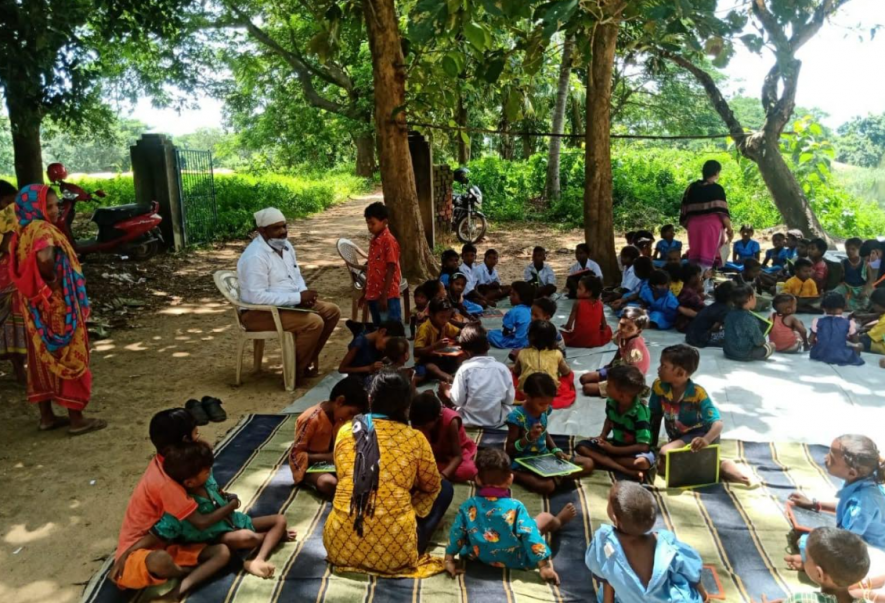 Teachers of Bhubanpur UP School teaching children at brick kiln worksites