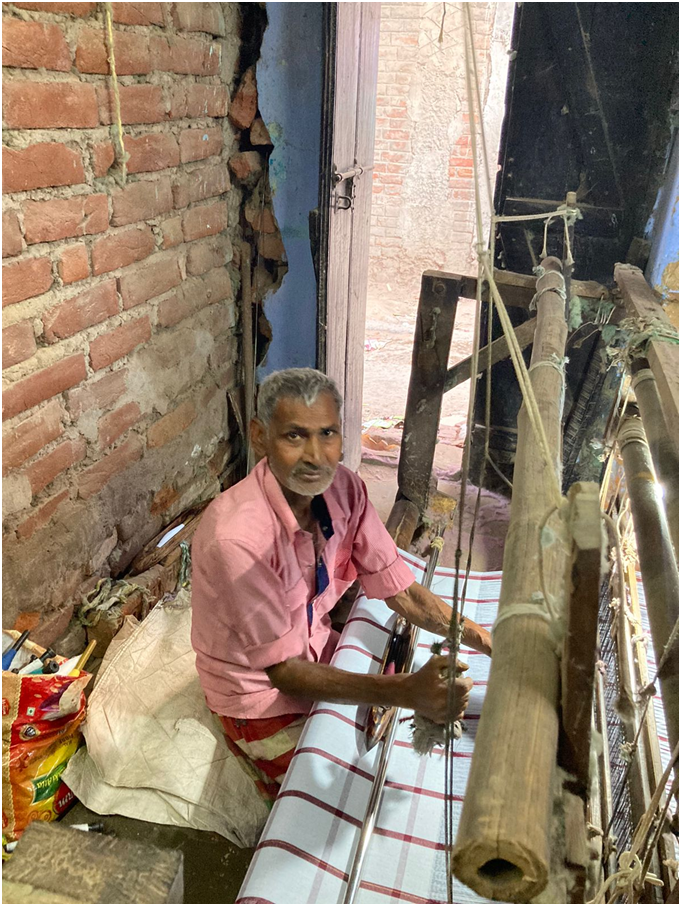 Nandlal working the handloom