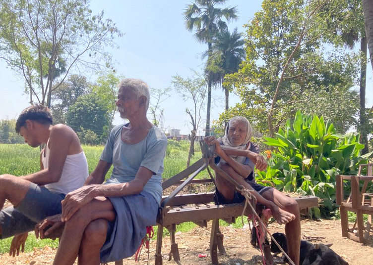 Village elders watch over the irrigation of fields