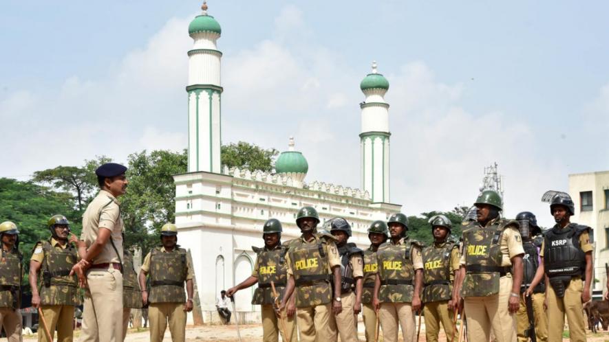 Police stand guard at Eidgah Maidan in Chamrajpet