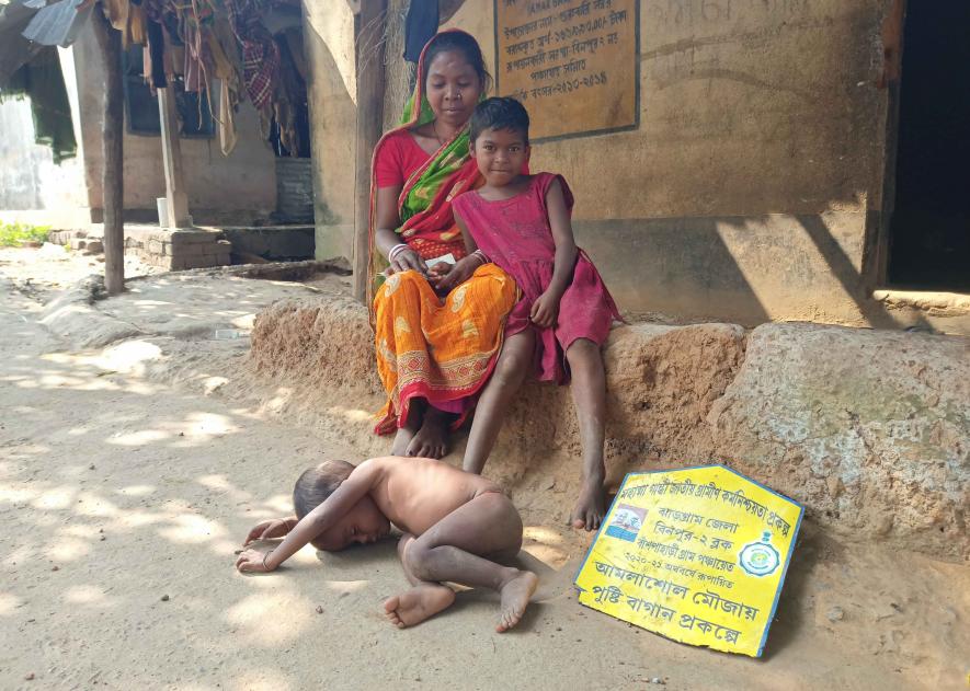 Puchhi Sabar with her mother and malnourished younger  brother Kaliya.