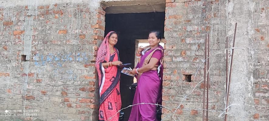 Chulbuli Parida and Smita Das are standing at the entrance of Smita’s half-constructed house