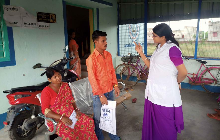 ASHA Mithu Chatait talks to a patient at Junbedia subcentre.