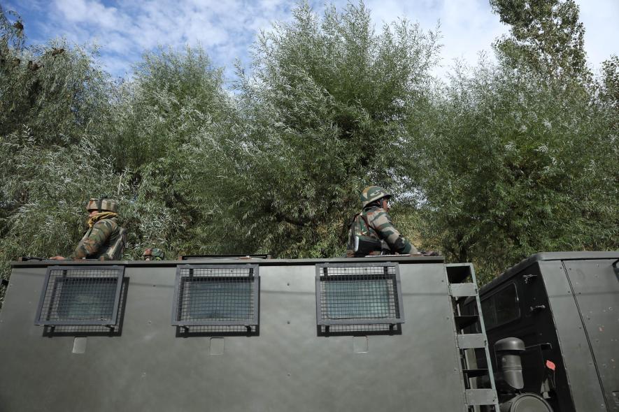 Army stands guard on a truck entering the area towards the encounter site.