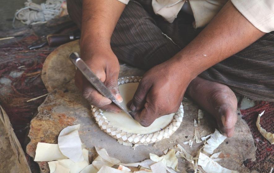 Mohammad Jaffer makes the tabla plate.