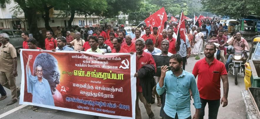 Transport employees union carry a banner that reads “red salutes to the departed leader”.