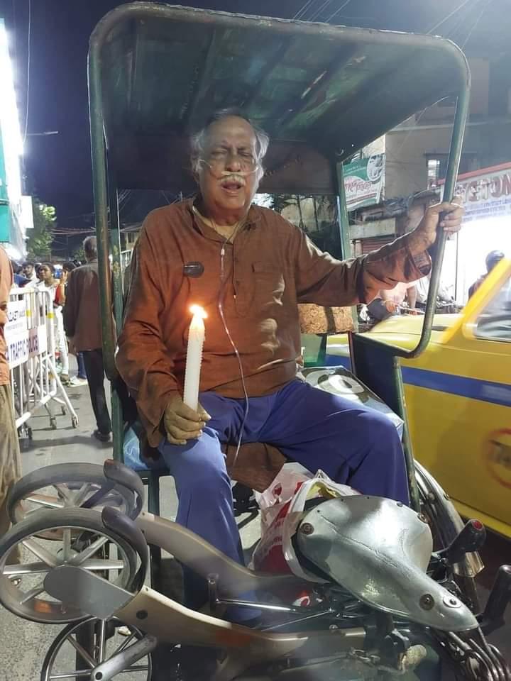 An old man in Kolkata holding a candle and demanding justice for Tilottama’s rape-murder