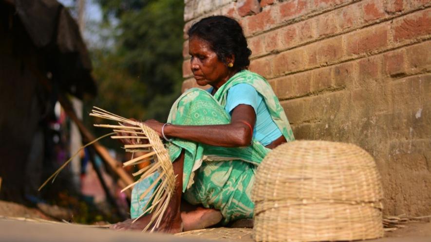 Ranu Bauri an old-age woman from Bhutsahar village under Bankura 2 Block is making bamboo baskets with a loan from Microfinance Company. Gramin bank reluctant to give loan.