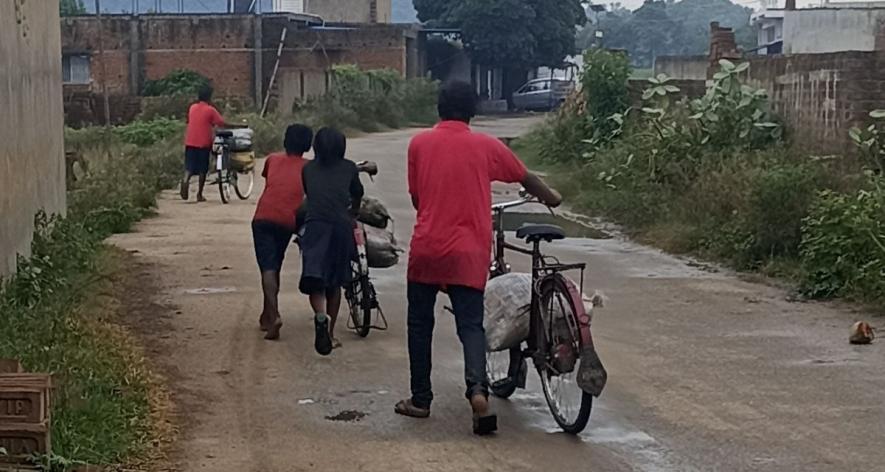 Children carrying coal on a bicycle to sell (Photo - Bharat Nayak, 101Reporters).